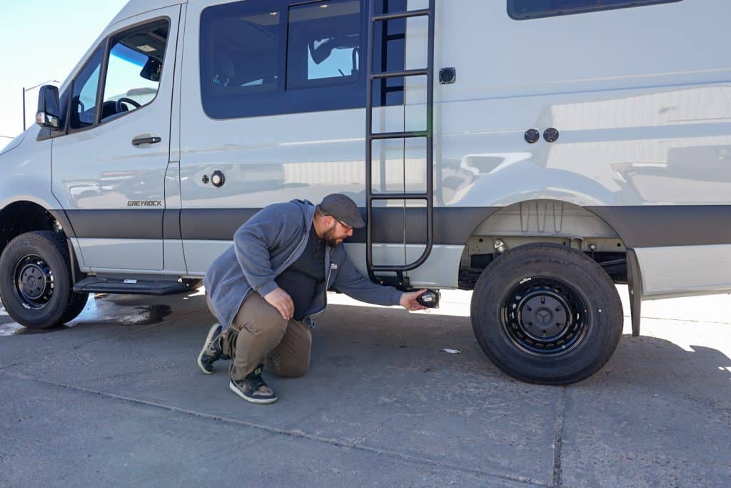 Located behind the rear tire on the driver's side is your grey water tank valve.