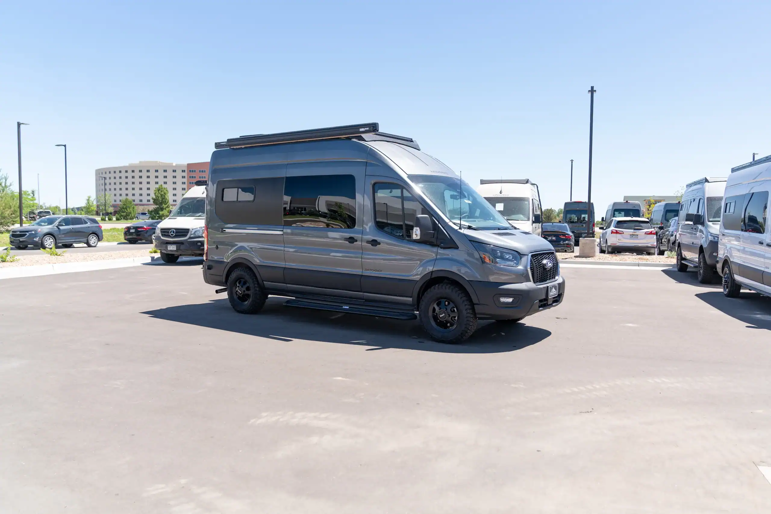 Black 2026 Switchback S4 Transit van parked in lot.