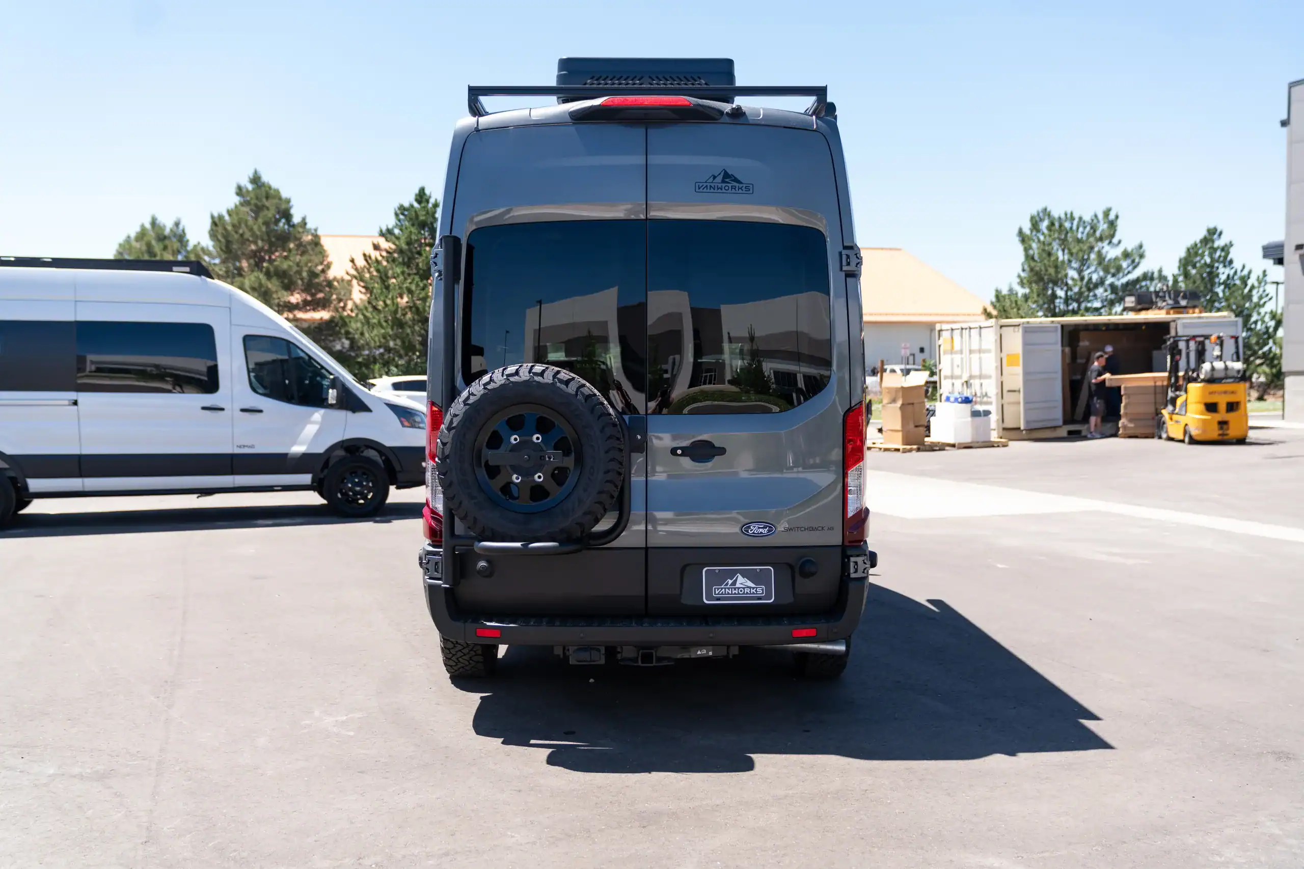 Rear view of 2026 Switchback S4 Transit van in parking lot.