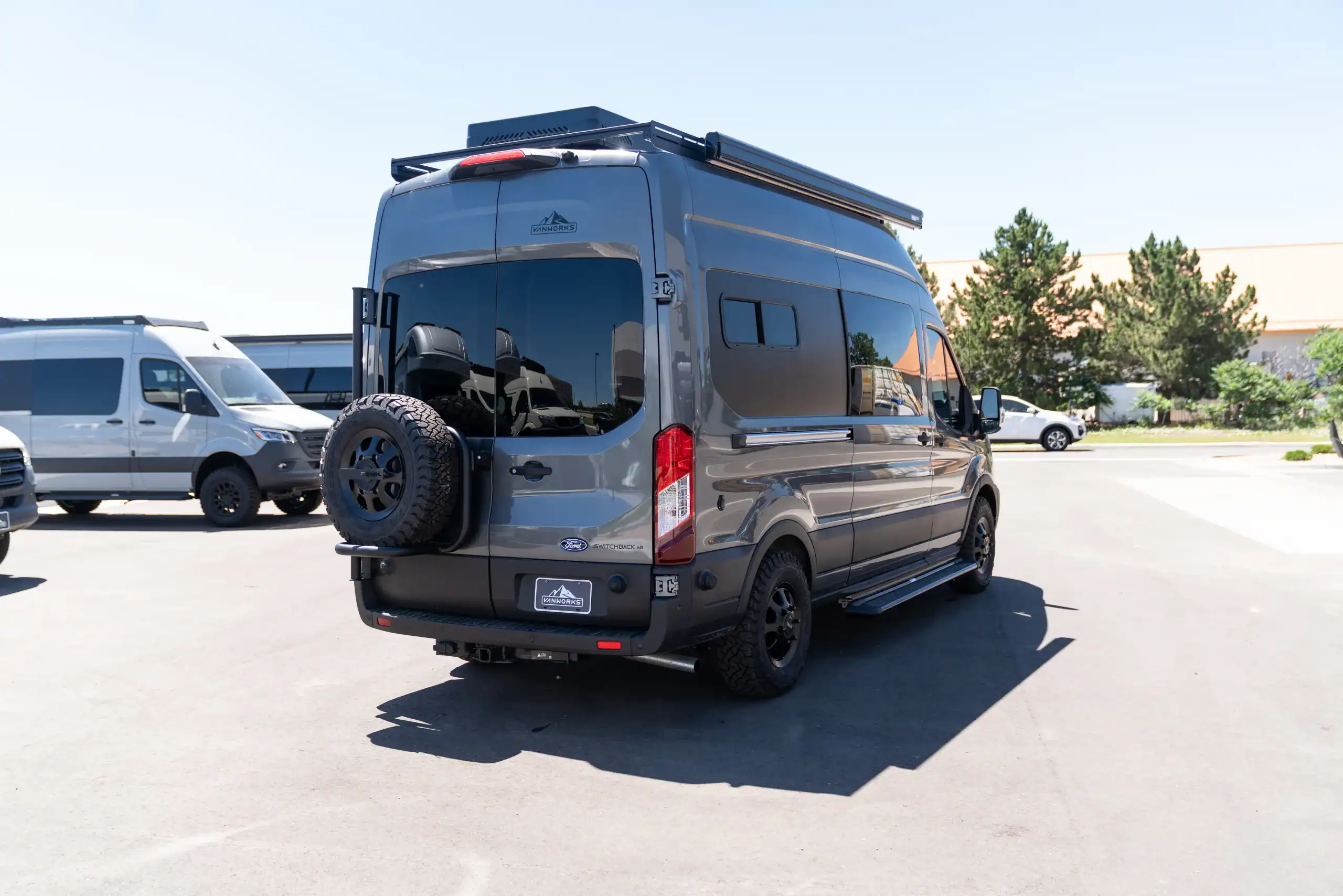 Custom camper van built on Ford Transit 148" wheelbase with rooftop storage.