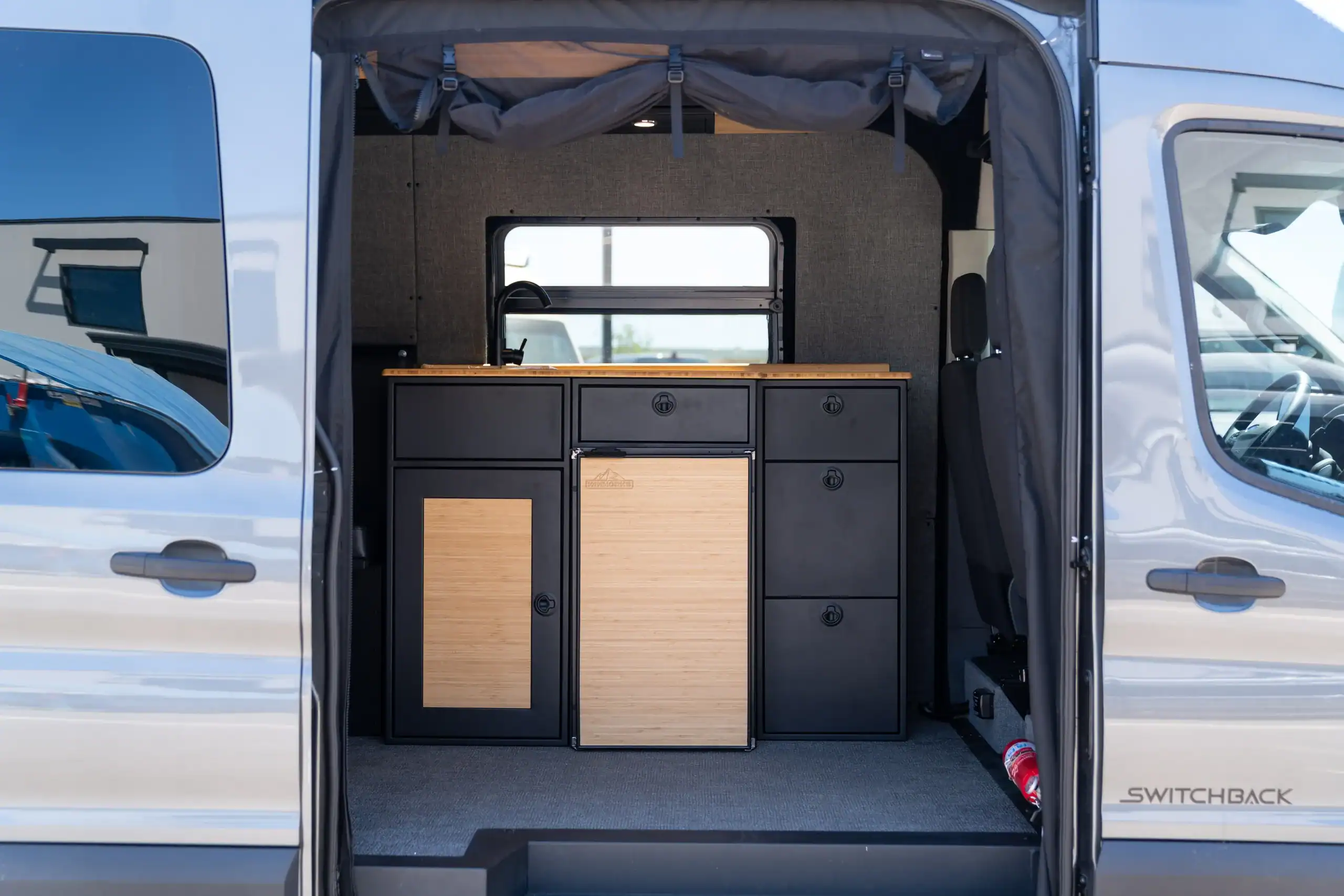 Interior view of the 2026 Switchback S4 Transit van with custom cabinetry.