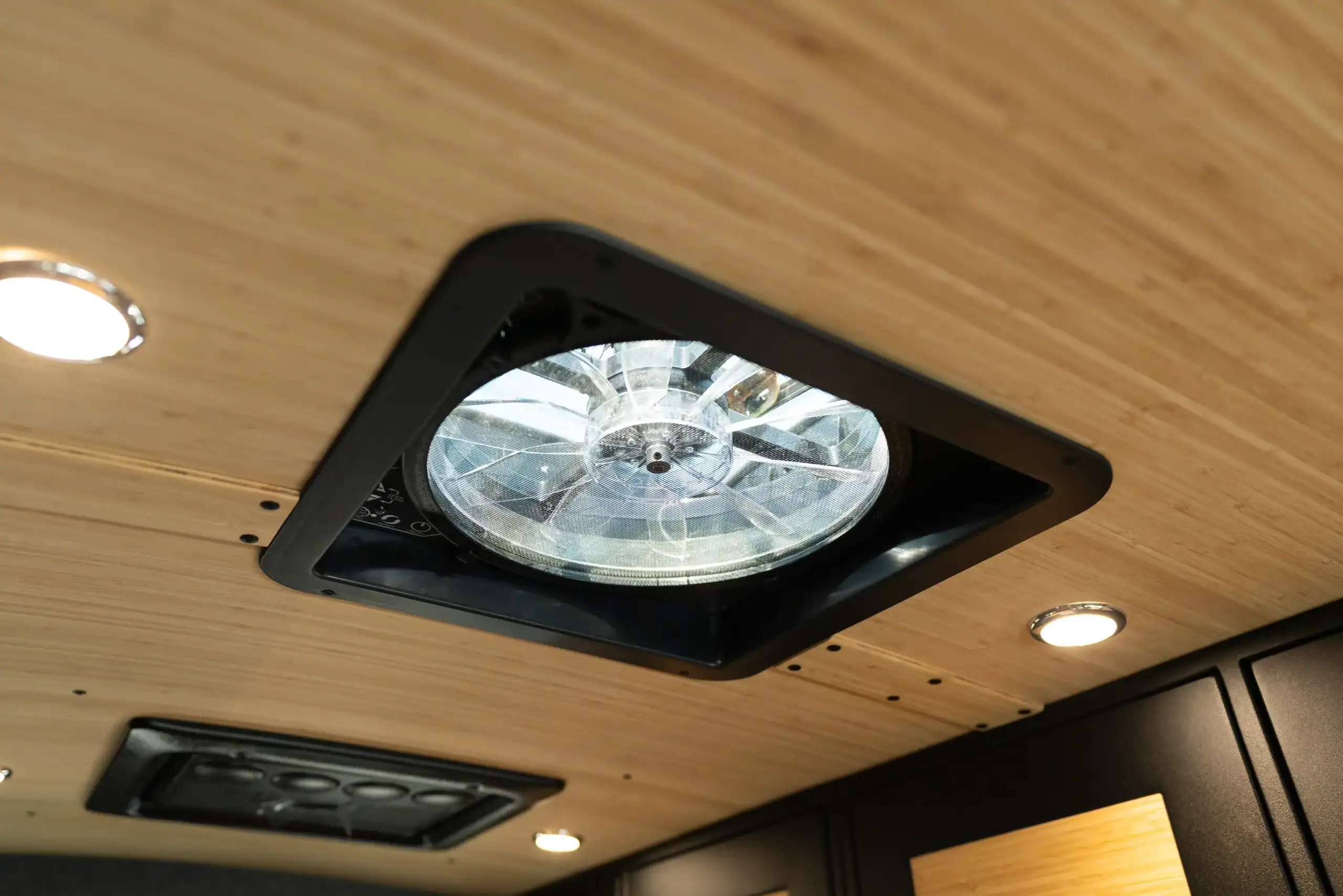 Interior ceiling light fixture in a custom van conversion by Vanworks.