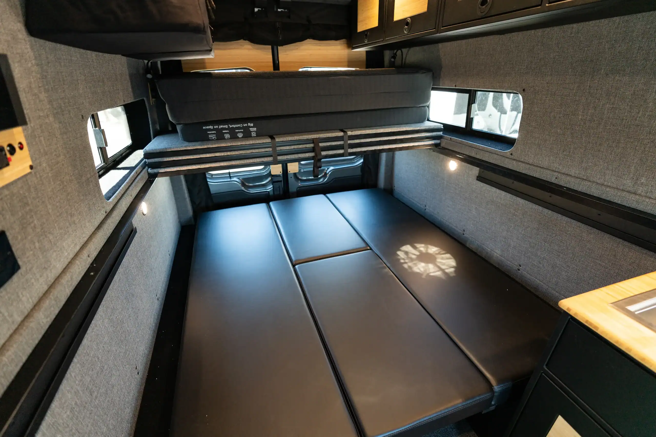 Interior of Vanworks 2026 Switchback S4 Transit with sleeping area and storage.
