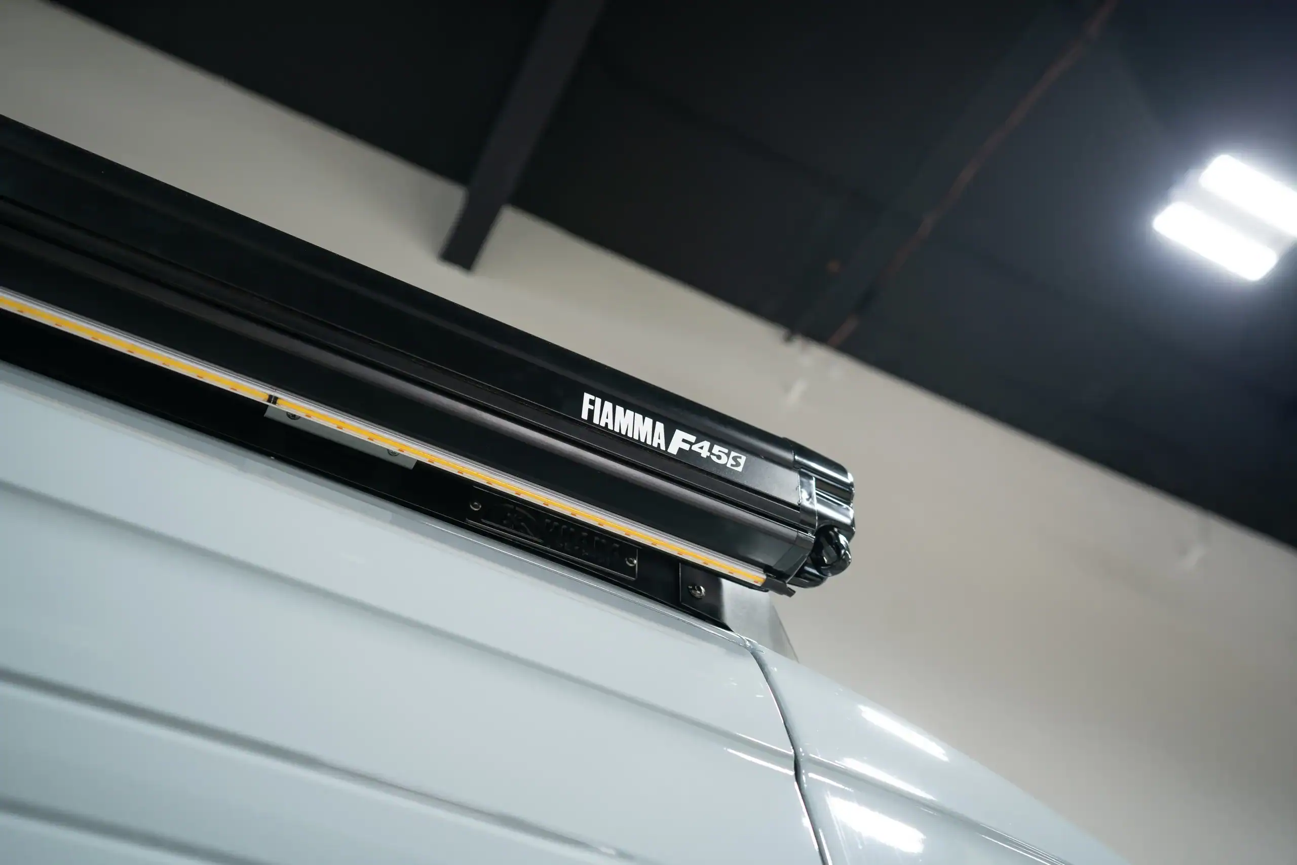 Fiamma F45S roof rack installed on van for outdoor gear storage.
