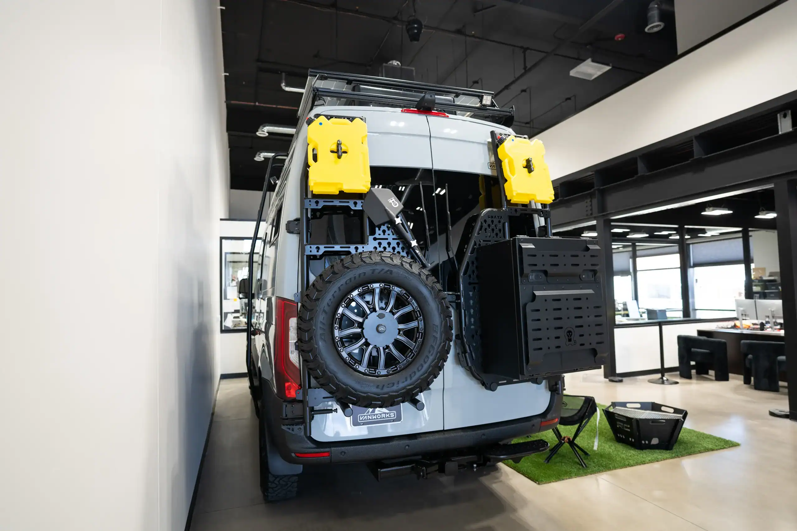 Vanworks Switchback Sprinter 144 with outdoor gear and spare tire.