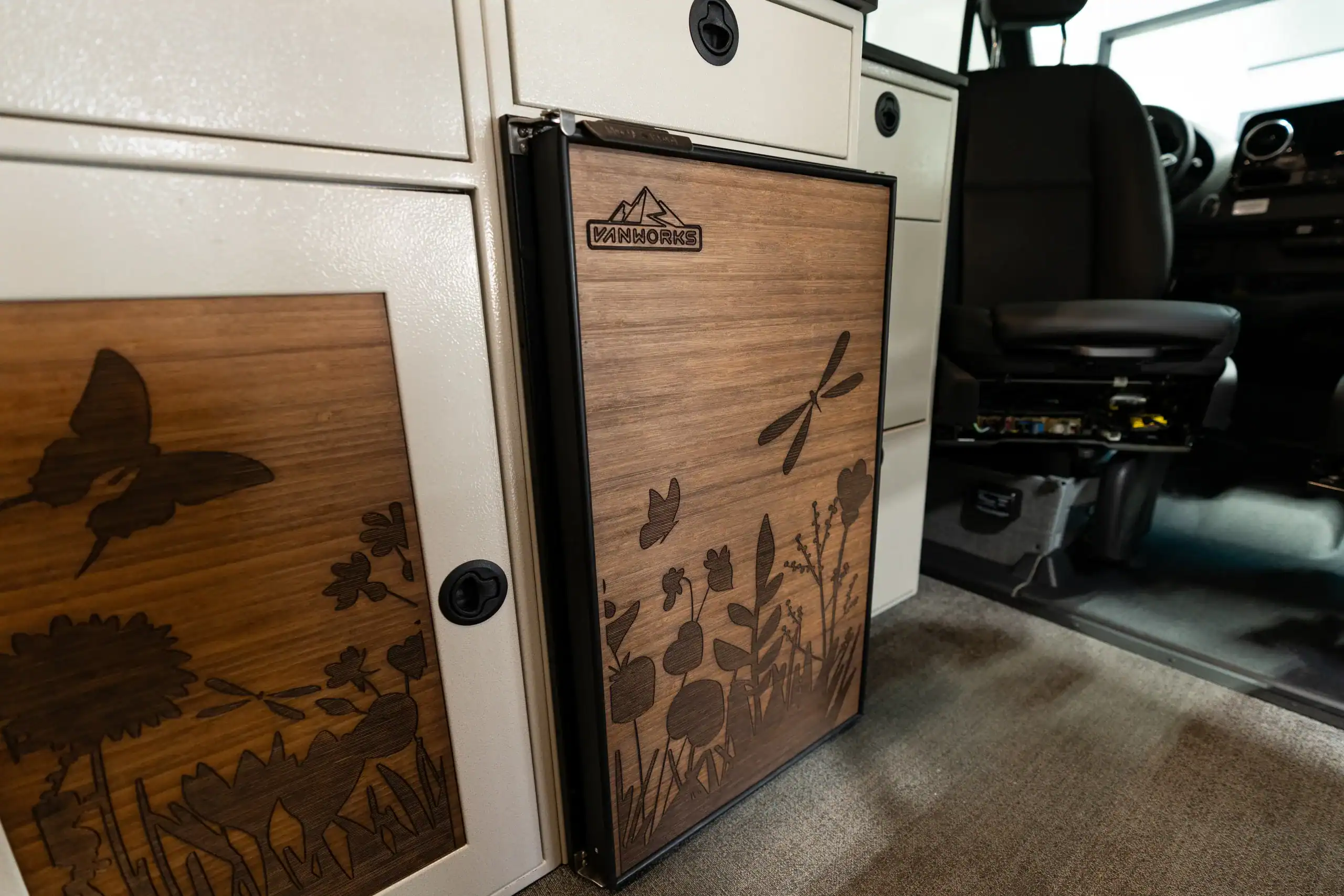 Interior of Vanworks Switchback Sprinter 144" showing custom cabinetry and wood accents.