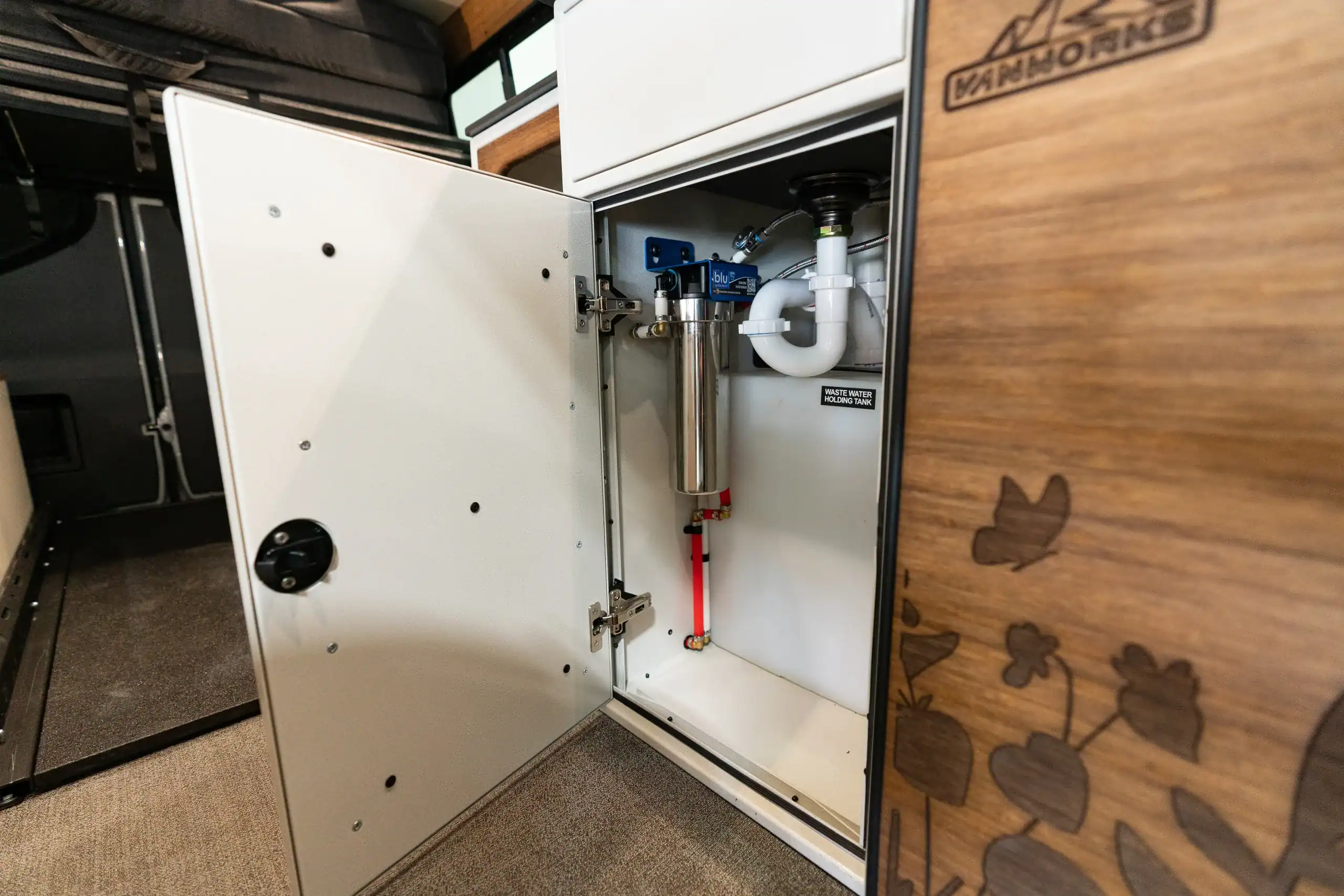 Interior plumbing setup in Vanworks Switchback Sprinter 144" show van.