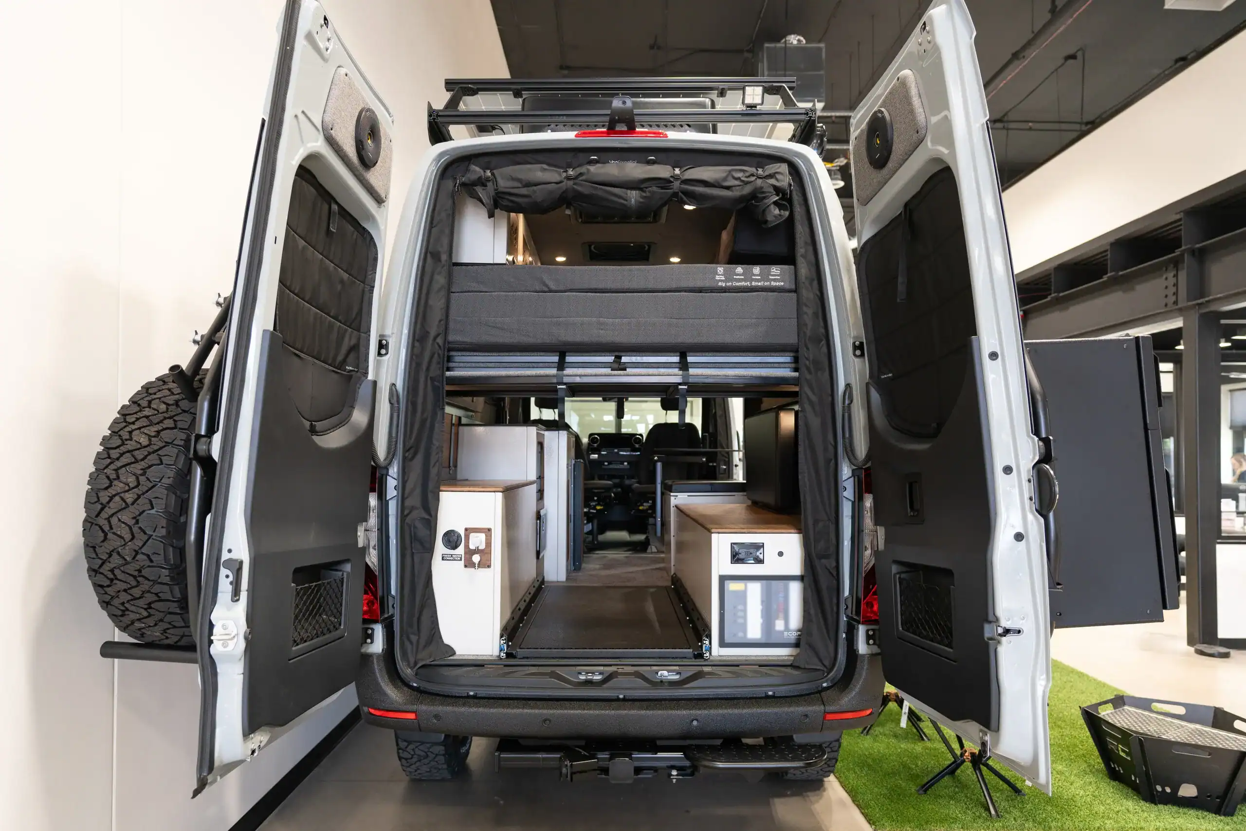 Interior view of the Switchback Sprinter 144" van with custom storage and sleeping area.