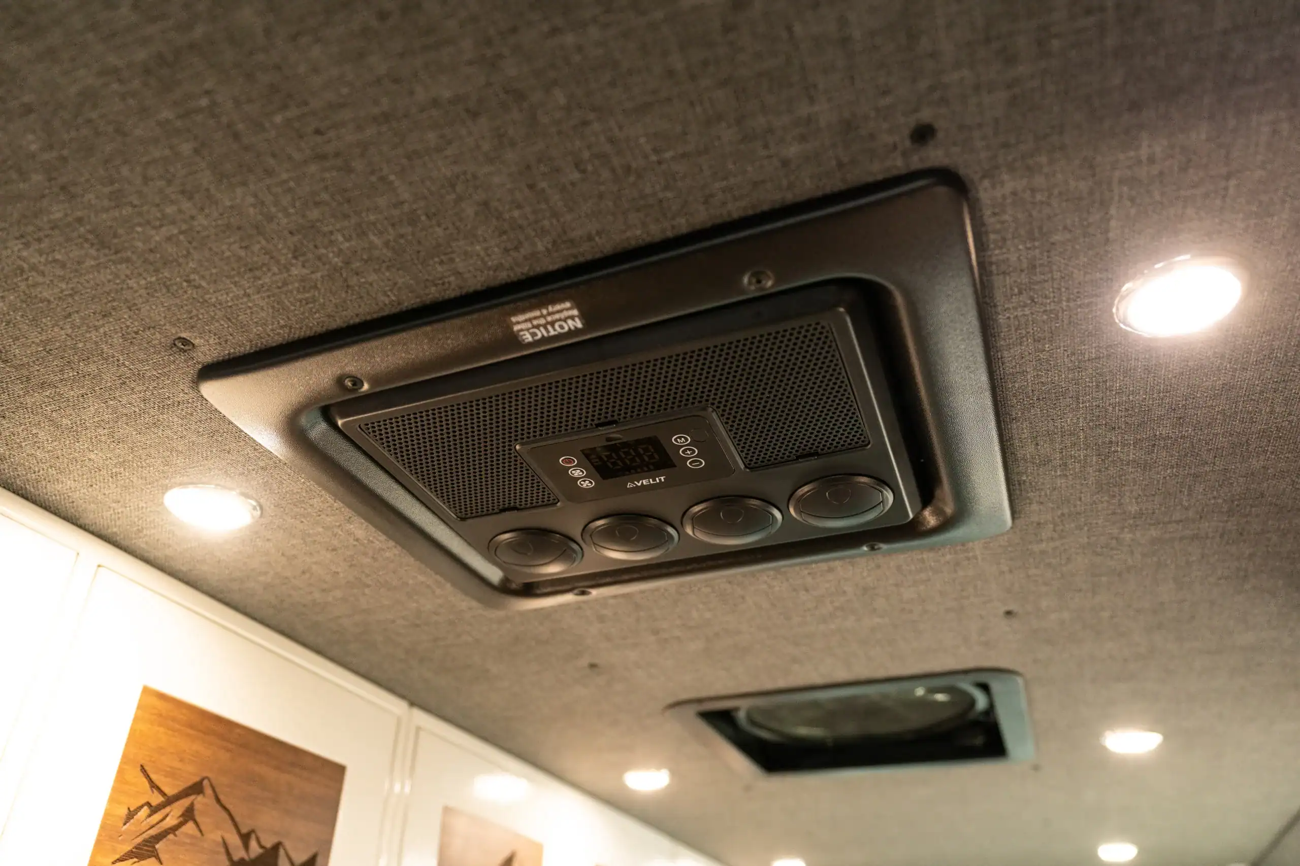 Custom van interior ceiling with air conditioning and lighting.