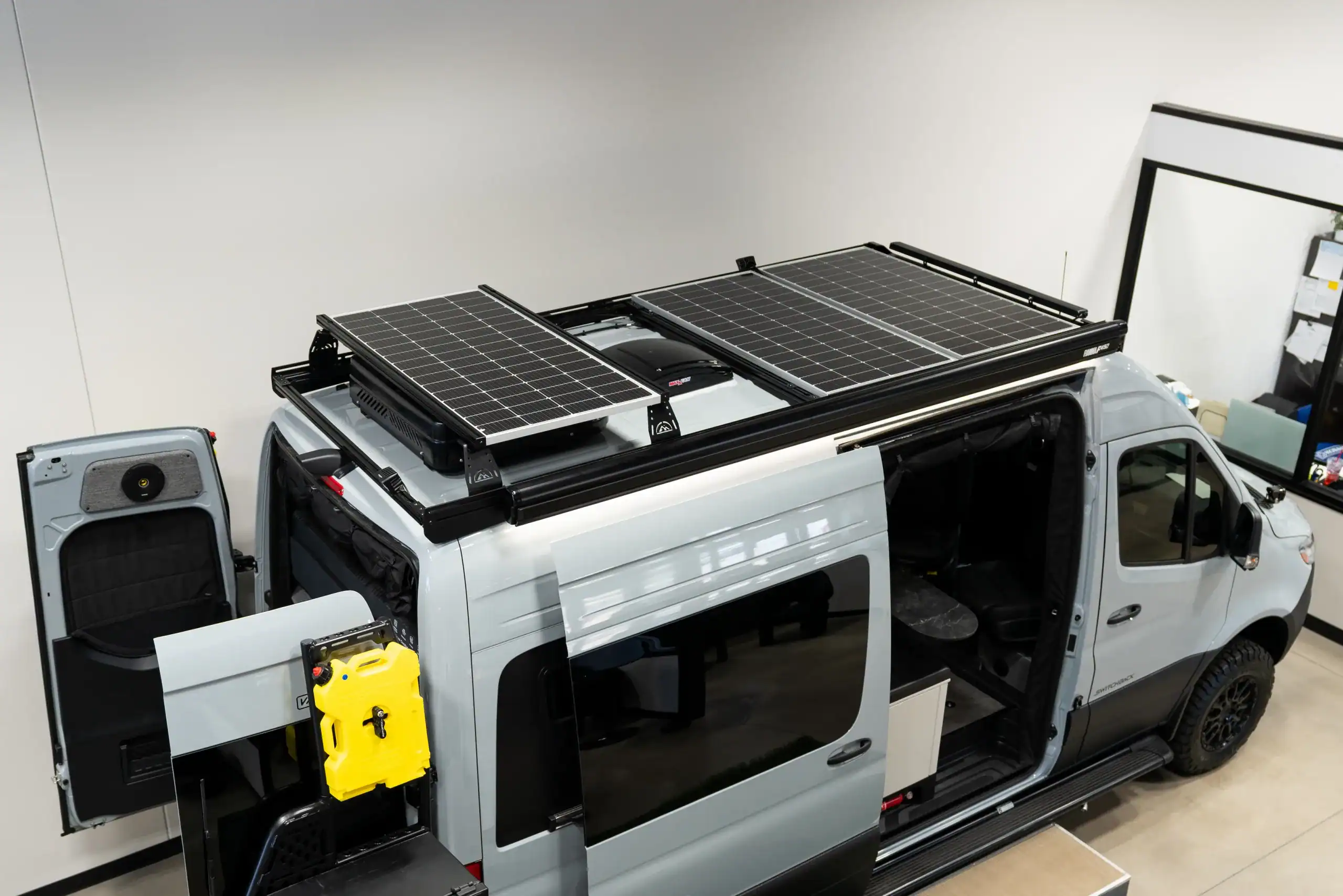 Custom van with solar panels and modular interior for camping.